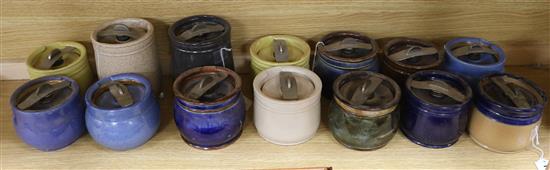Fourteen Doulton tobacco jars in plain colours with patent pressure sealing fitments